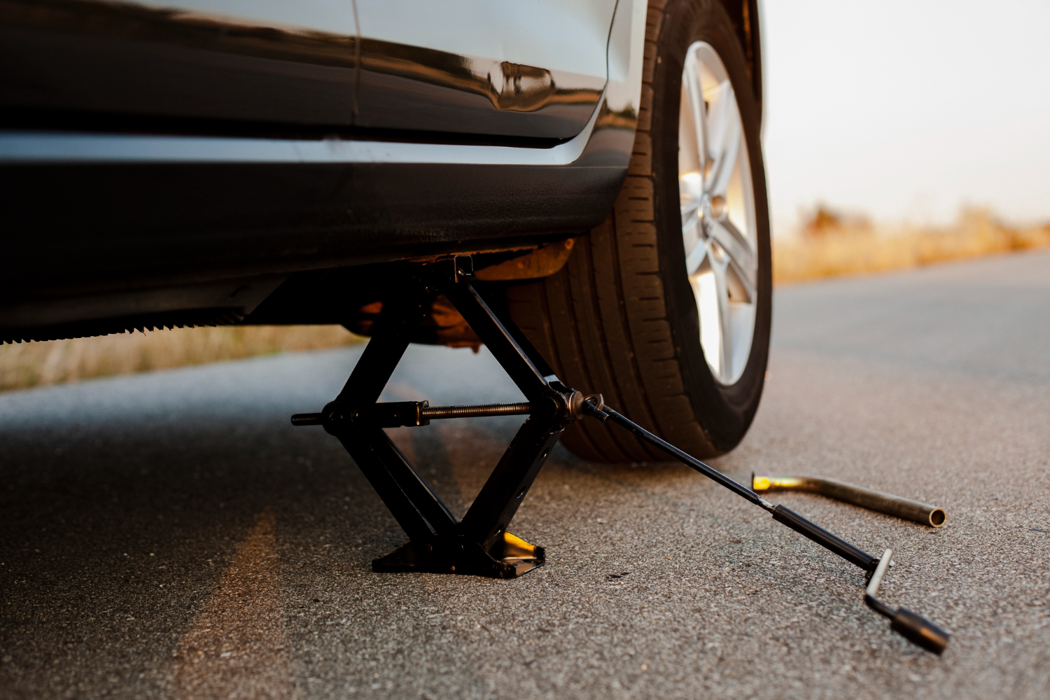 black car lifted up by jack screw 1